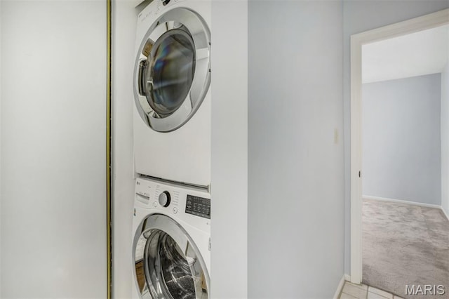 12975 Bryce Canyon Dr Unit D, Maryland Heights, MO 63043 - washroom featuring stacked washer / dryer and carpet