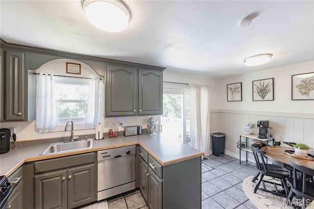 3712 Gail Dr, Imperial, MO 63052 - kitchen with dishwasher, a peninsula, gray cabinets, light tile patterned floors, and a wainscoted wall