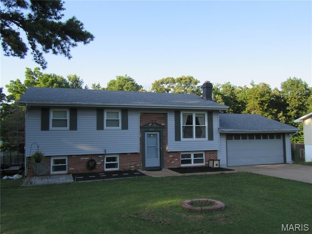 3712 Gail Dr, Imperial, MO 63052 - split foyer home with an attached garage, driveway, a front yard, a chimney, and brick siding