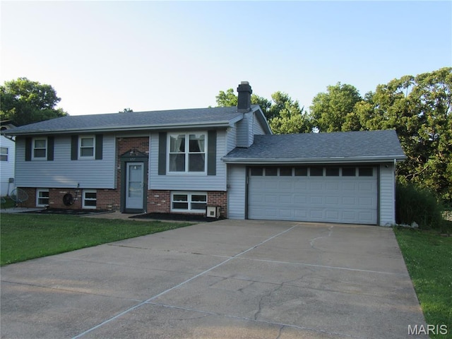 3712 Gail Dr, Imperial, MO 63052 - raised ranch with concrete driveway, an attached garage, a chimney, and a front yard