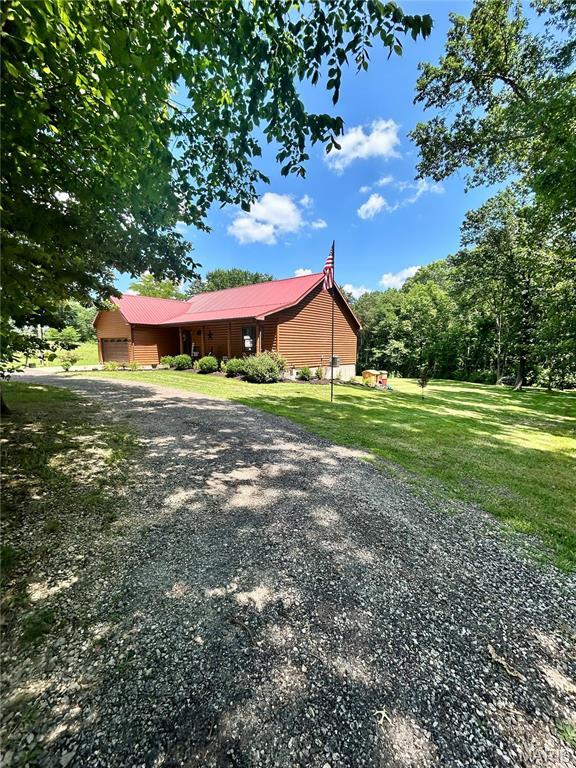 5156 Mccallister Rd, Gerald, MO 63037 - view of side of property with an attached garage, a lawn, and driveway
