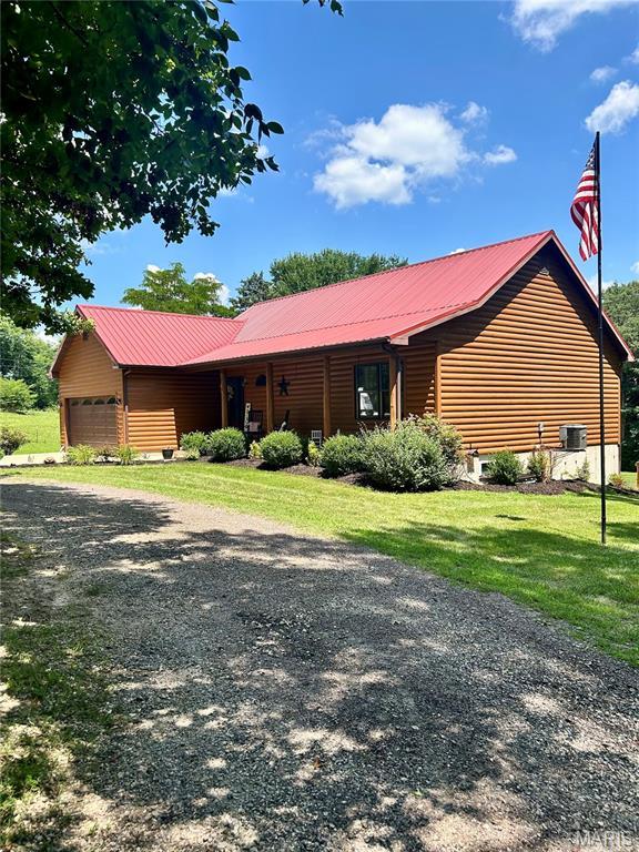5156 Mccallister Rd, Gerald, MO 63037 - view of front of property with a front lawn, a metal roof, and an attached garage