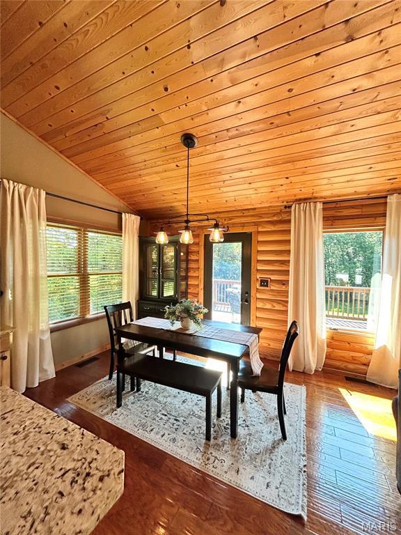 5156 Mccallister Rd, Gerald, MO 63037 - dining space featuring plenty of natural light, wood ceiling, dark wood finished floors, lofted ceiling, and rustic walls