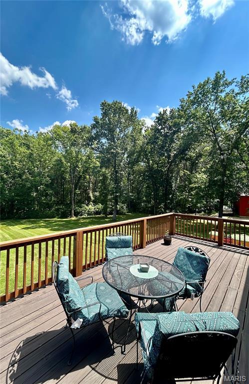 5156 Mccallister Rd, Gerald, MO 63037 - wooden deck with outdoor dining area and a lawn