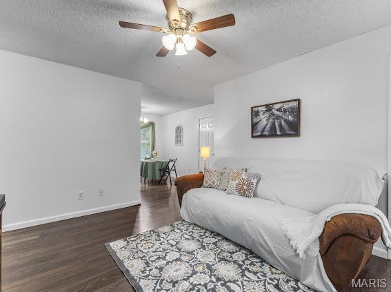 4213 Flucom Rd, De Soto, MO 63020 - living area featuring a textured ceiling, a ceiling fan, and wood finished floors