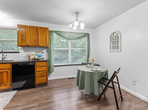 4213 Flucom Rd, De Soto, MO 63020 - dining space with a textured ceiling, a chandelier, dark wood-style flooring, and healthy amount of natural light