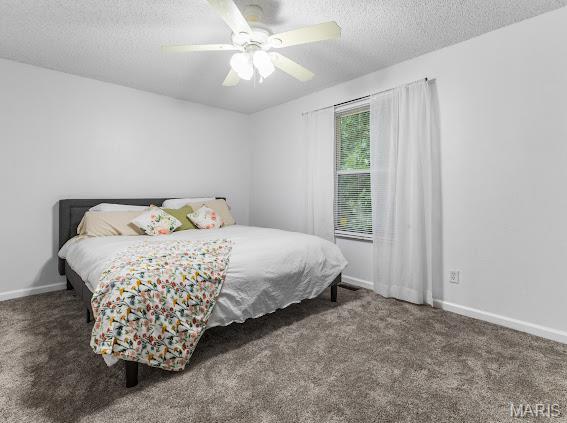 4213 Flucom Rd, De Soto, MO 63020 - bedroom with carpet, a textured ceiling, and a ceiling fan