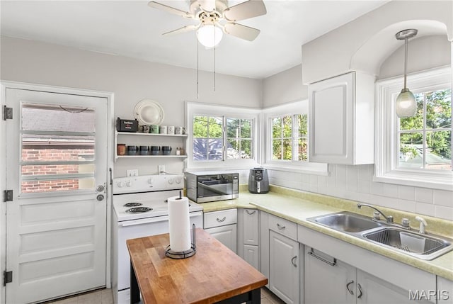 1106 Danforth St, Alton, IL 62002 - kitchen with electric stove, stainless steel microwave, a ceiling fan, hanging light fixtures, and backsplash