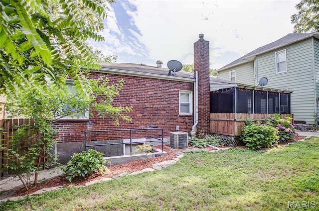 1106 Danforth St, Alton, IL 62002 - back of property with a sunroom, brick siding, a chimney, and a garden