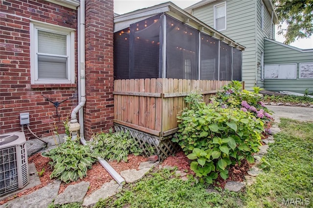 1106 Danforth St, Alton, IL 62002 - view of property exterior with a sunroom and brick siding