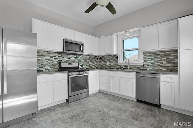 111 N Duncan St, Marine, IL 62061 - kitchen with stainless steel appliances, a ceiling fan, decorative backsplash, white cabinetry, and dark countertops