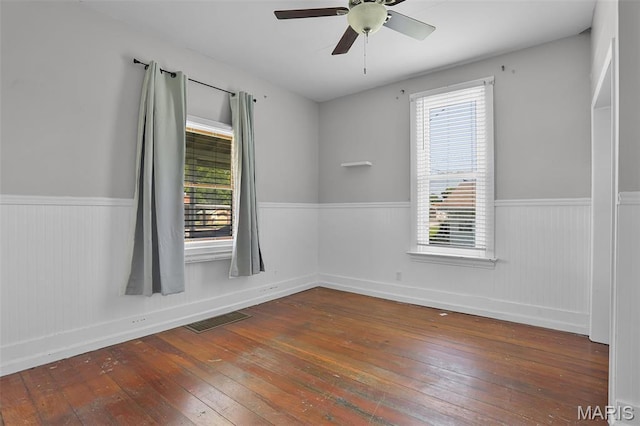 111 N Duncan St, Marine, IL 62061 - spare room with wood-type flooring, wainscoting, plenty of natural light, and a ceiling fan