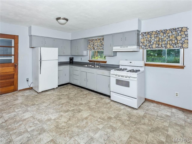 118 Alice Dr, Ofallon, IL 62269 - kitchen featuring white appliances, gray cabinetry, under cabinet range hood, and dark countertops