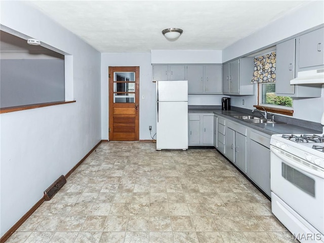 118 Alice Dr, Ofallon, IL 62269 - kitchen with white appliances, gray cabinets, dark countertops, under cabinet range hood, and stone finish floors
