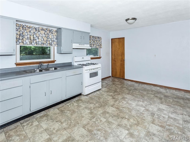 118 Alice Dr, Ofallon, IL 62269 - kitchen with gas range gas stove, under cabinet range hood, stone finish floors, and dark countertops