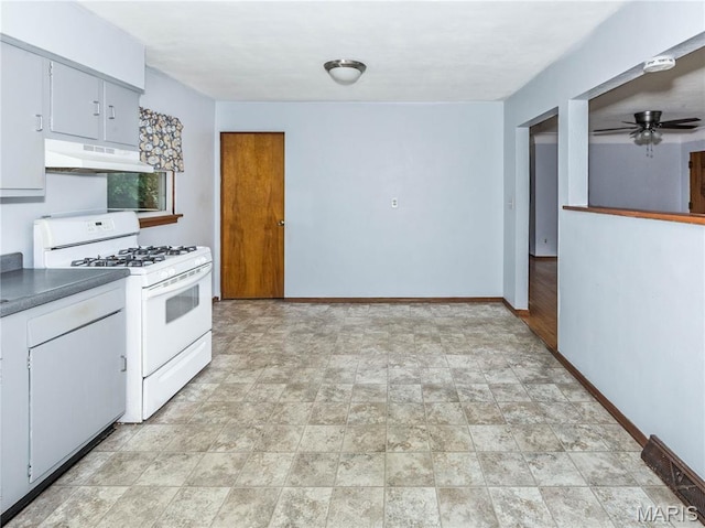 118 Alice Dr, Ofallon, IL 62269 - kitchen featuring white gas range oven, under cabinet range hood, stone finish flooring, and ceiling fan