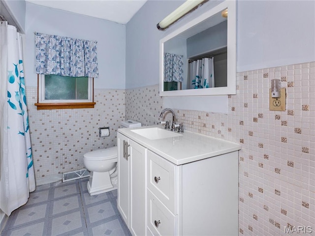 118 Alice Dr, Ofallon, IL 62269 - bathroom with tile walls, vanity, a wainscoted wall, and a shower with curtain