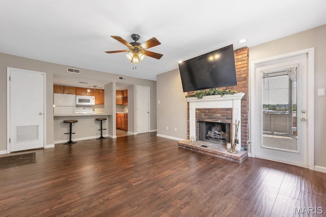 4 Fairways Cir Unit I, Saint Charles, MO 63303 - unfurnished living room with a ceiling fan, dark wood-style flooring, and a brick fireplace