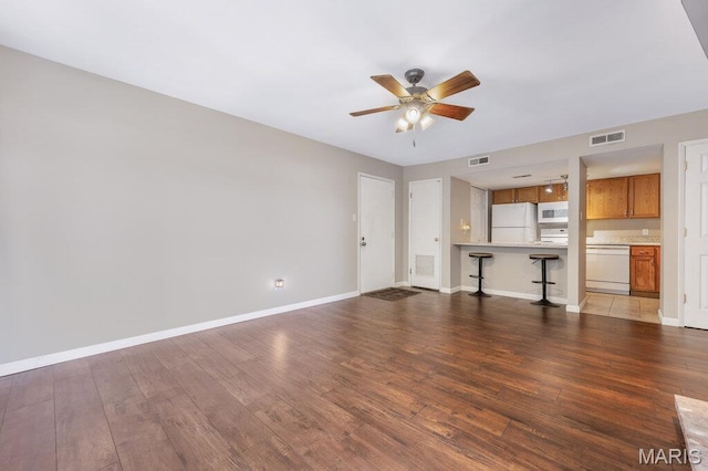 4 Fairways Cir Unit I, Saint Charles, MO 63303 - unfurnished living room featuring a ceiling fan and wood finished floors