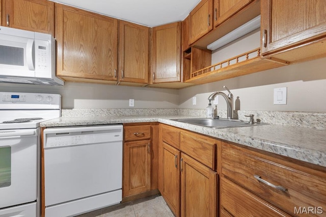 4 Fairways Cir Unit I, Saint Charles, MO 63303 - kitchen featuring white appliances, light countertops, brown cabinets, and light tile patterned floors