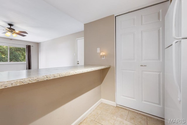 4 Fairways Cir Unit I, Saint Charles, MO 63303 - kitchen with freestanding refrigerator, ceiling fan, light countertops, and light tile patterned floors