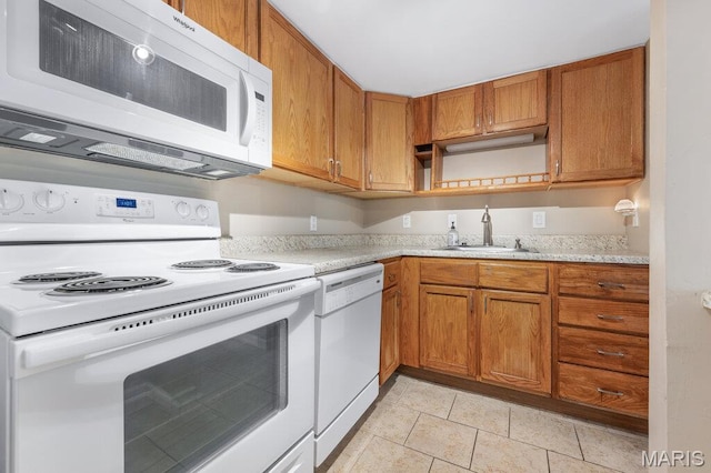 4 Fairways Cir Unit I, Saint Charles, MO 63303 - kitchen with white appliances, light countertops, brown cabinets, and light tile patterned flooring