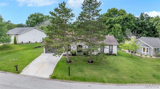 904 Ampere Pl, Lake St Louis, MO 63367 - view of front of home featuring concrete driveway, a front yard, a garage, and view of scattered trees