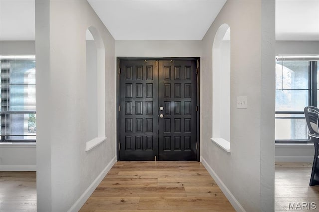 904 Ampere Pl, Lake St Louis, MO 63367 - foyer entrance featuring arched walkways, light wood-style floors, and healthy amount of natural light