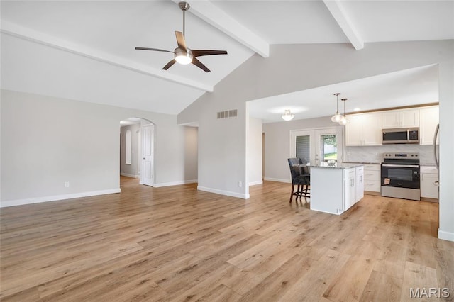 904 Ampere Pl, Lake St Louis, MO 63367 - kitchen with stainless steel appliances, open floor plan, a kitchen breakfast bar, white cabinetry, and beam ceiling