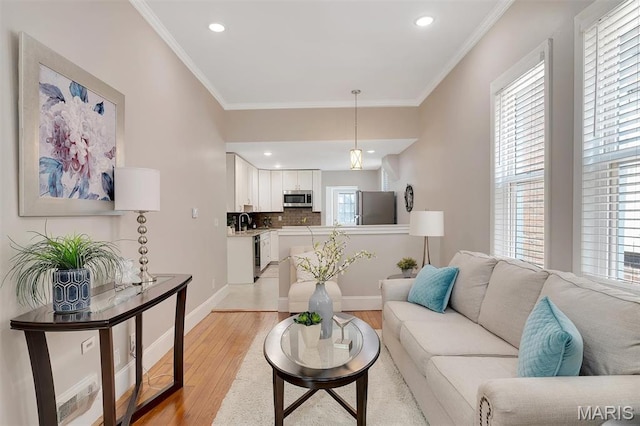3253 Walter Ave, Maplewood, MO 63143 - living room with healthy amount of natural light, light wood-style floors, ornamental molding, and recessed lighting