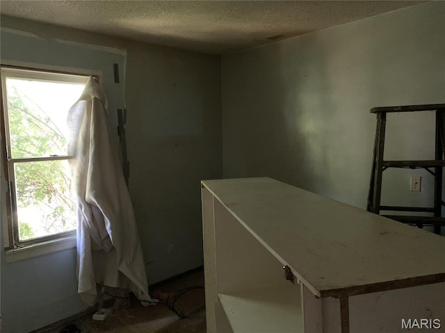 8268 Brenner Ave, Saint Louis, MO 63114 - empty room featuring a textured ceiling and baseboards