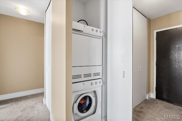 210 N 17th St Unit 1005, Saint Louis, MO 63103 - washroom featuring stacked washer / dryer and light carpet