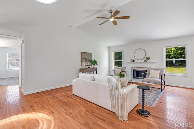 3848 Bedford Pointe Dr, Wentzville, MO 63385 - living room featuring plenty of natural light, a ceiling fan, a high end fireplace, lofted ceiling, and light wood finished floors