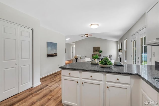 3848 Bedford Pointe Dr, Wentzville, MO 63385 - kitchen with ceiling fan, light wood-type flooring, white cabinets, a peninsula, and vaulted ceiling