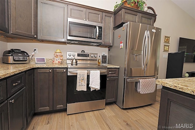 3576 Mill View Xing, Cape Girardeau, MO 63701 - kitchen featuring stainless steel appliances, light wood finished floors, dark brown cabinetry, and light stone countertops