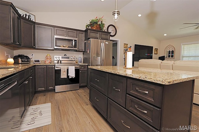 3576 Mill View Xing, Cape Girardeau, MO 63701 - kitchen featuring appliances with stainless steel finishes, lofted ceiling, light wood-type flooring, light stone counters, and dark brown cabinetry