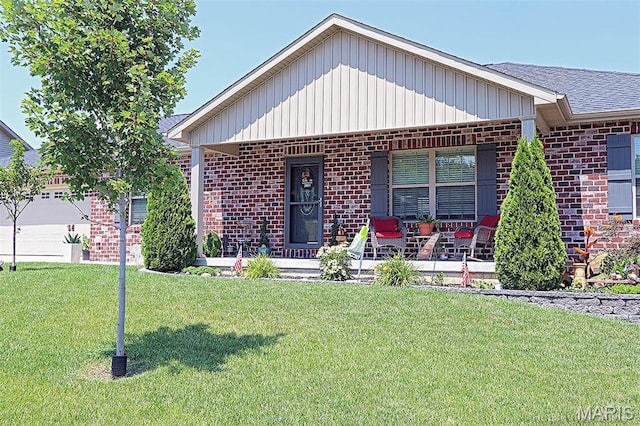 3576 Mill View Xing, Cape Girardeau, MO 63701 - ranch-style home with brick siding, covered porch, a front yard, and board and batten siding