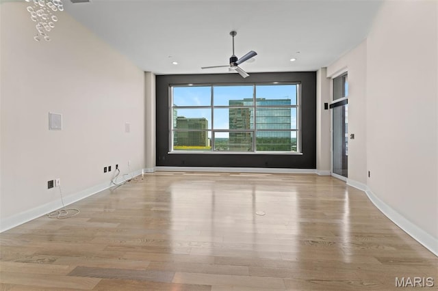 8025 Maryland Ave Unit 8H, Clayton, MO 63105 - spare room featuring a ceiling fan, wood finished floors, and recessed lighting