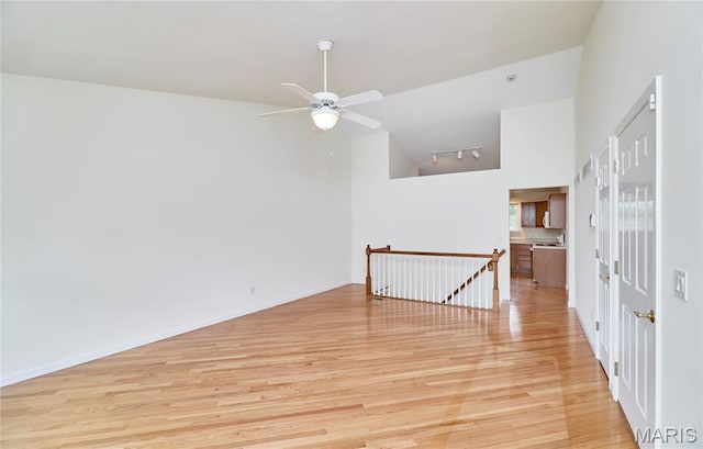 108 Fort Worth Way, Wright City, MO 63390 - empty room featuring light wood-style floors, a ceiling fan, rail lighting, and high vaulted ceiling