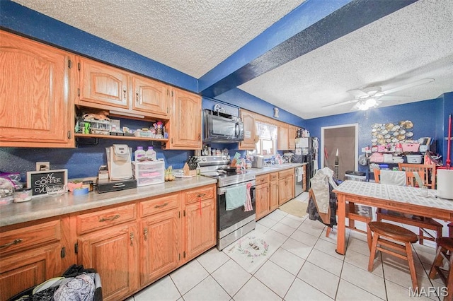 110 S Oak St, Rolla, MO 65401 - kitchen with stainless steel appliances, a textured ceiling, light countertops, light tile patterned floors, and a ceiling fan