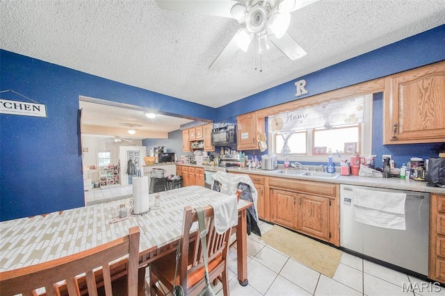 110 S Oak St, Rolla, MO 65401 - kitchen with stainless steel appliances, a ceiling fan, light tile patterned flooring, a textured ceiling, and light countertops
