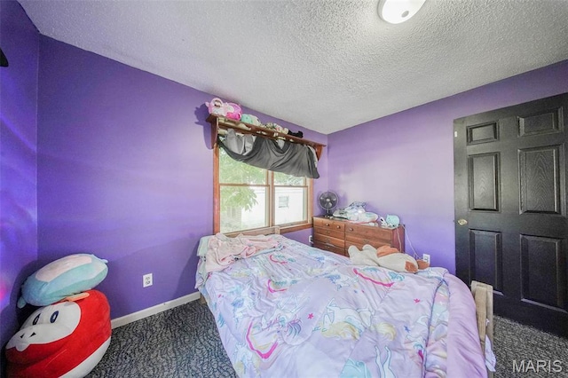 110 S Oak St, Rolla, MO 65401 - carpeted bedroom featuring a textured ceiling and baseboards