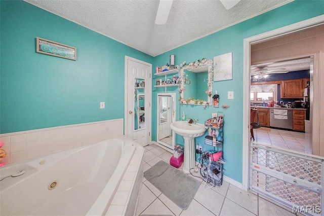 110 S Oak St, Rolla, MO 65401 - bathroom featuring a ceiling fan, tile patterned flooring, a jetted tub, and a textured ceiling
