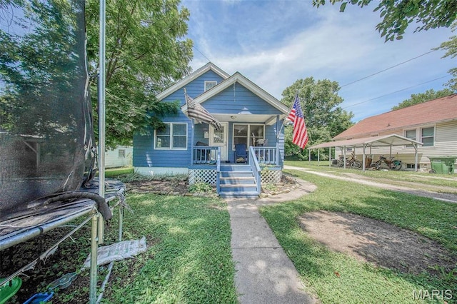 110 S Oak St, Rolla, MO 65401 - bungalow-style house featuring covered porch, a trampoline, and a front lawn