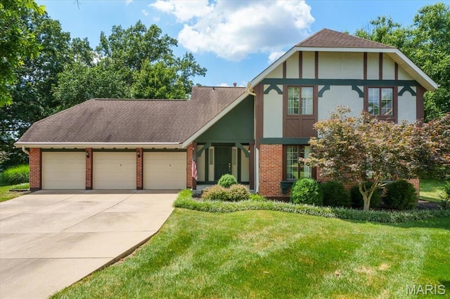 15693 Dresden Lake Ct, Chesterfield, MO 63017 - english style home featuring an attached garage, concrete driveway, a front yard, brick siding, and roof with shingles