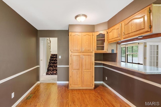 15693 Dresden Lake Ct, Chesterfield, MO 63017 - kitchen with light wood finished floors and glass insert cabinets