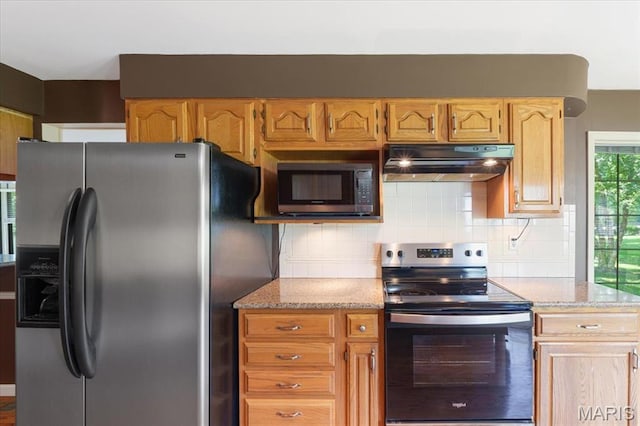 15693 Dresden Lake Ct, Chesterfield, MO 63017 - kitchen with stainless steel appliances, under cabinet range hood, backsplash, and light stone countertops