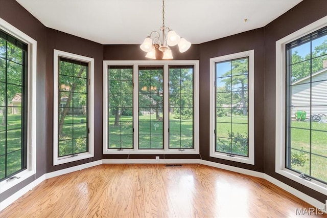 15693 Dresden Lake Ct, Chesterfield, MO 63017 - unfurnished dining area featuring a chandelier, light wood-style floors, and healthy amount of natural light