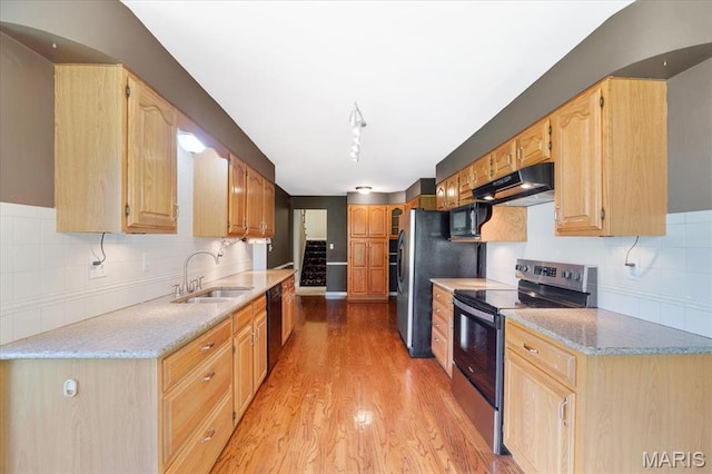 15693 Dresden Lake Ct, Chesterfield, MO 63017 - kitchen featuring black appliances, under cabinet range hood, light wood finished floors, decorative backsplash, and light stone countertops