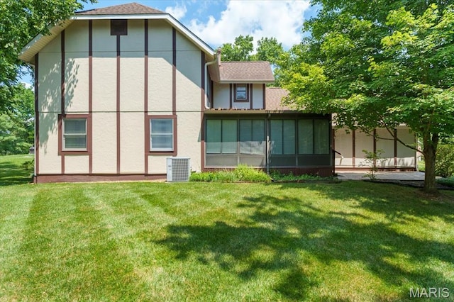 15693 Dresden Lake Ct, Chesterfield, MO 63017 - rear view of property featuring stucco siding, a lawn, and a sunroom